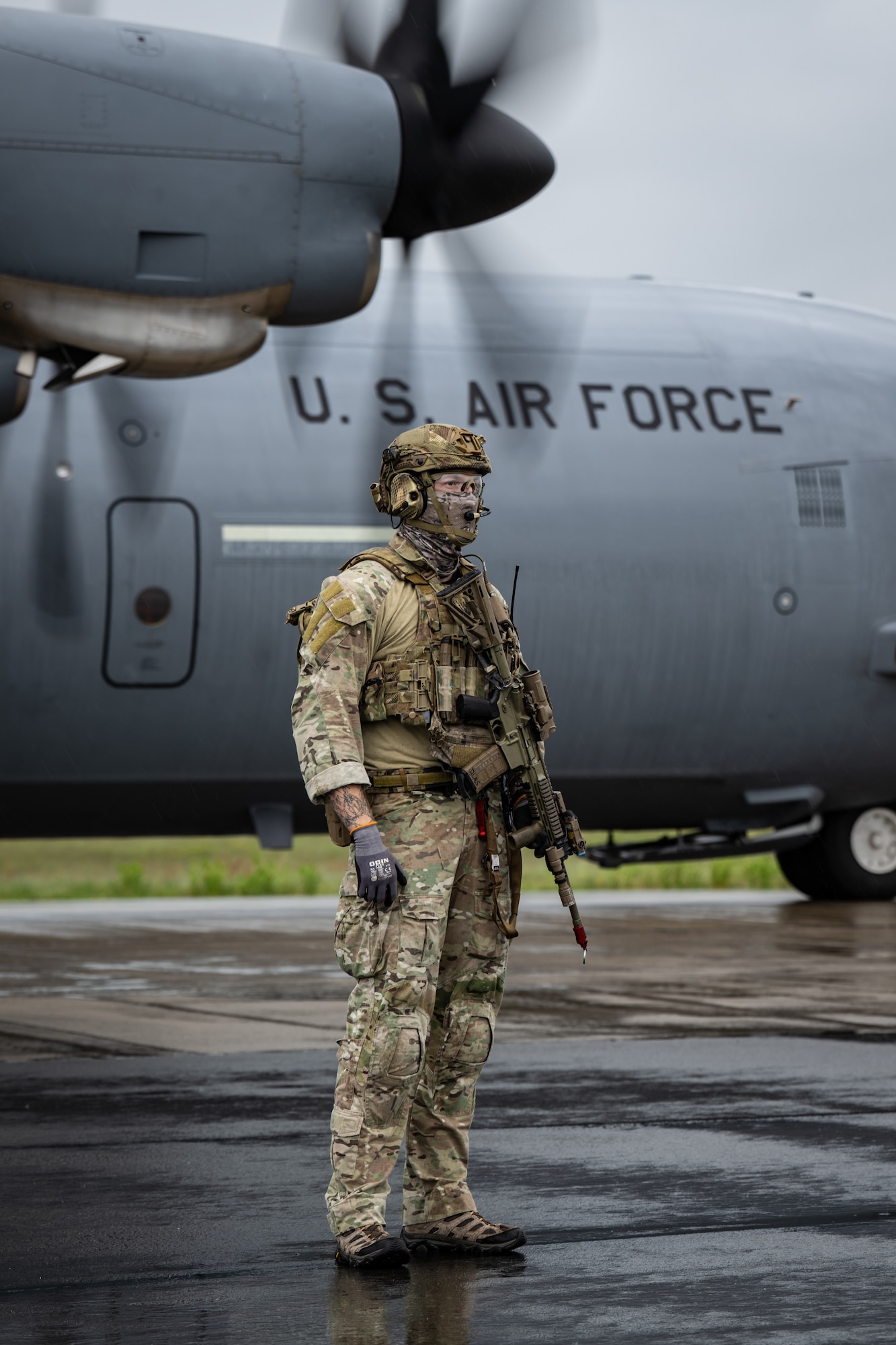 A member of the Danish Armed Forces provides perimeter security for a U.S. Air Force C-130J Super Hercules aircraft assigned to  the 123rd Airlift Wing, Kentucky Air National Guard, during a search-and-recovery training scenario at Rygge Air Station, Norway, June 9, 2026. The 123rd AW is providing tactical airlift to NATO Allies throughout the month of June in support of Ramstein Flag 2026, an Allied Air Command large-scale, multi-location and joint operating area exercise with 18 participating nations and more than 200 aircraft. (U.S. Air National Guard photo by Lt. Col. Dale Greer)