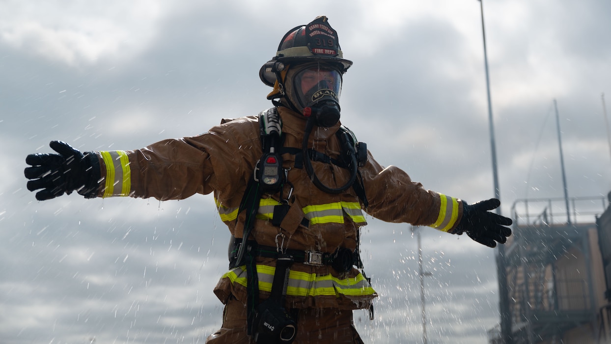U.S. Air Force firefighter is sprayed with water after an emergency response exercise at the Louis F. Garland Department of War Fire Academy, Goodfellow Air Force Base, Texas, June 10, 2026.