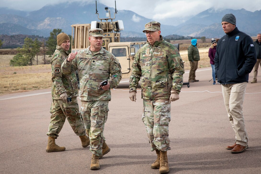 U.S. military service men walk on a military base.
