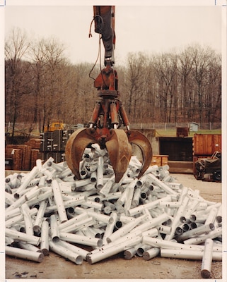A crane grabs aluminum containers.
