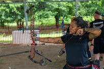 Retired Sgt. 1st Class Valerie Watkins aims her arrow during an archery practice session at an archery range on Joint Base San Antonio-Fort Sam Houston, Texas, June 10, 2026.