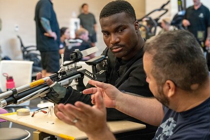 U.S. Army Sgt. Elon Smith receives instruction from Head Coach Marco Delarosa during a precision air training session at the 2026 Warrior Games Training Camp in San Antonio, Texas, June 10, 2026.