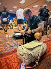 Chief Warrant Officer 3 Jon Tallman organizes his gear and equipment bags during the Team Army uniform distribution event In San Antonio, Texas, June 10, 2026.