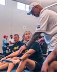 U.S. Army Maj. Patricia Zumwalt receives instruction from Team Army coach, Greg Quarles, during an indoor rowing training session for the 2026 Warrior Games in San Antonio, Texas, June 12, 2026.