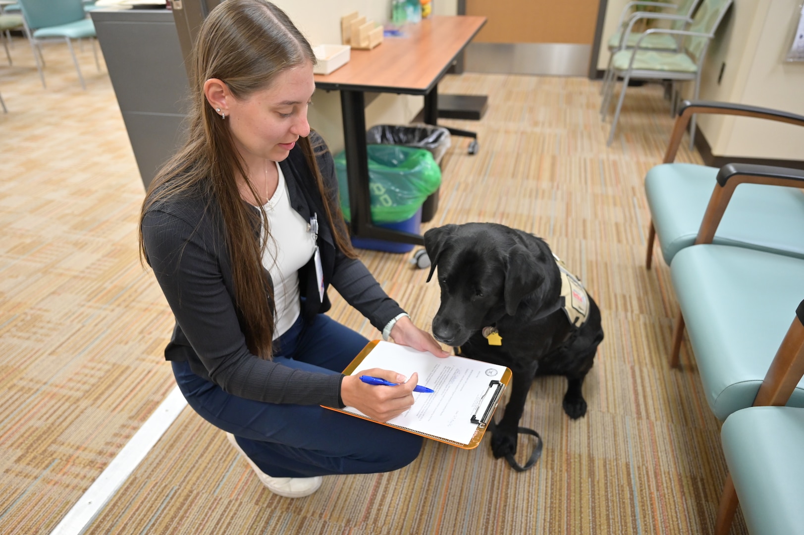 Solomon “reviews” intake paperwork with 1st Lt. Stephanie Gay during a Nutrition Care Division appointment. Similar forms help patients identify their goals, discuss barriers to success, and create realistic plans for long-term health. While Solomon appeared interested in the paperwork, he declined to comment on whether he had read the fine print.