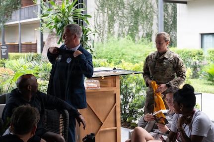 Dr. Tyler Bennett (left), Army Recovery Care Program Director, receives Team Army paraphernalia from Maj. Casey Turner (right),