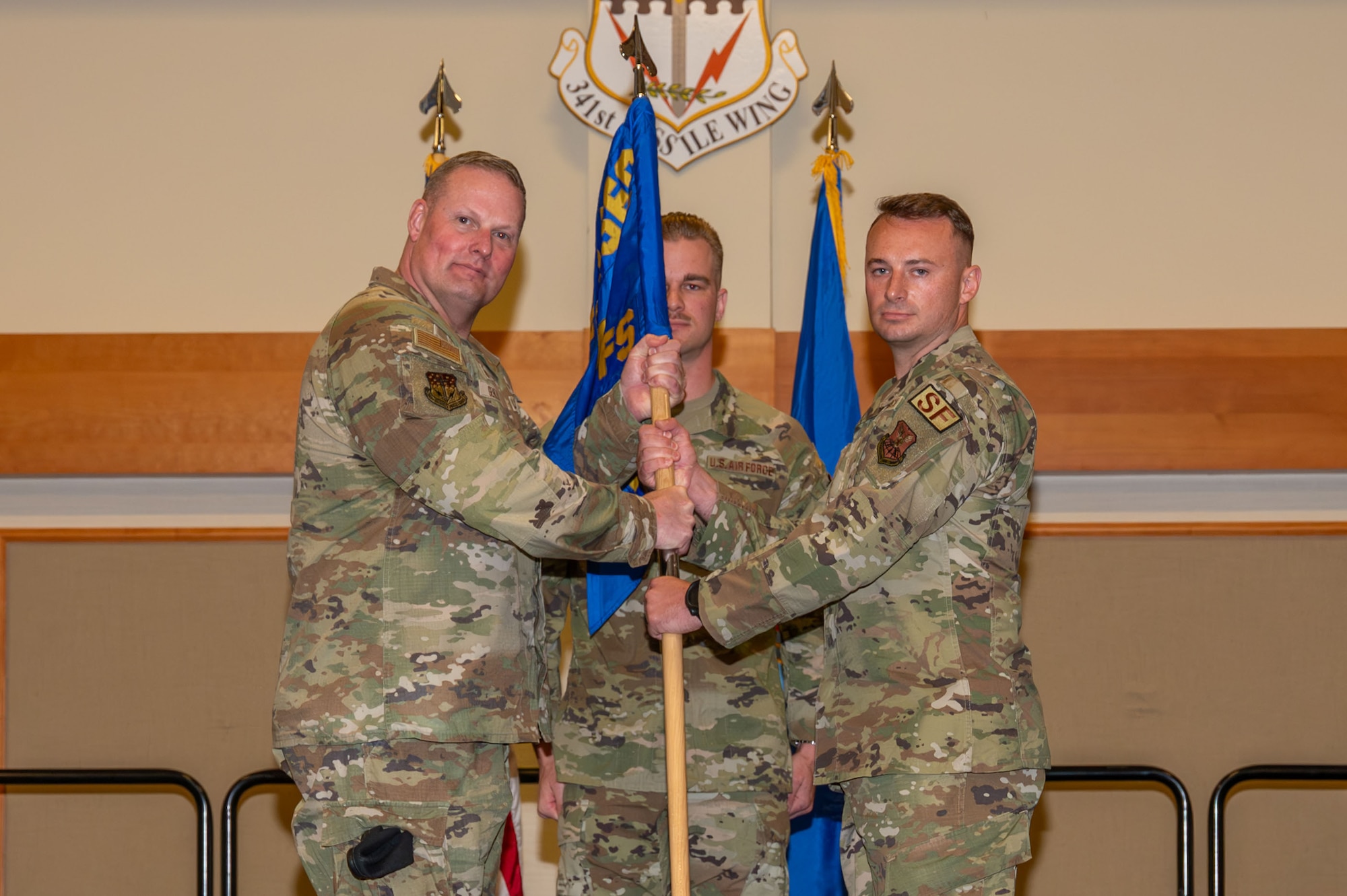 U.S. Air Force Maj. Ricky Sizemore Jr., right, accepts command of the 741st Missile Security Forces Squadron from Col. Drew Gehler, 341st Security Forces Group commander, during a change of command ceremony at Malmstrom Air Force Base, Montana, June 16, 2026.