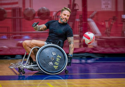 Retired U.S. Army Chief Warrant Officer 3 Jonathan Tallman turns to receive ball as he participates in wheelchair rugby training for the 2026 Warrior Games in San Antonio, Texas, June 10, 2026.