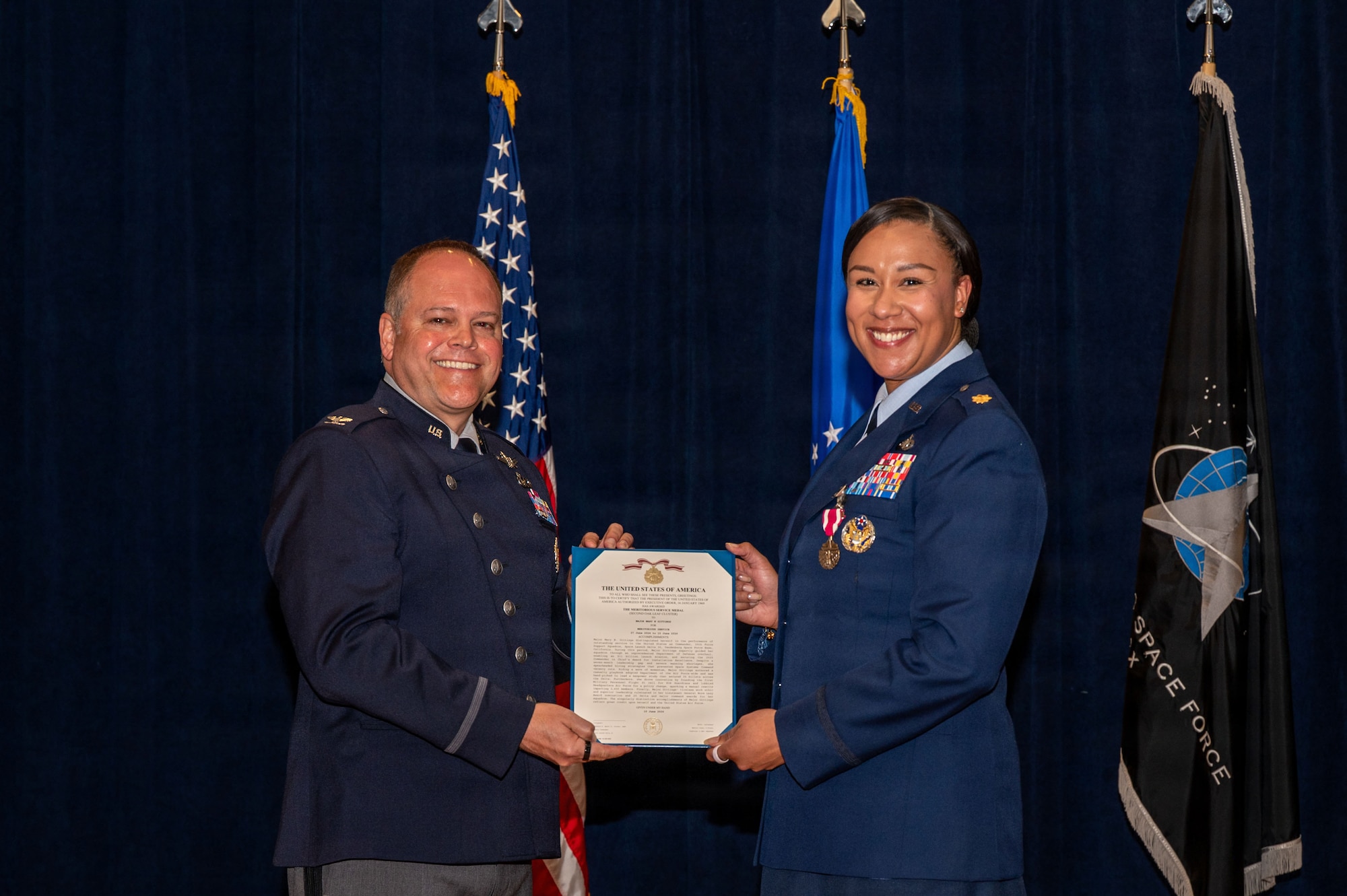 a person presents an award to another person on a stage