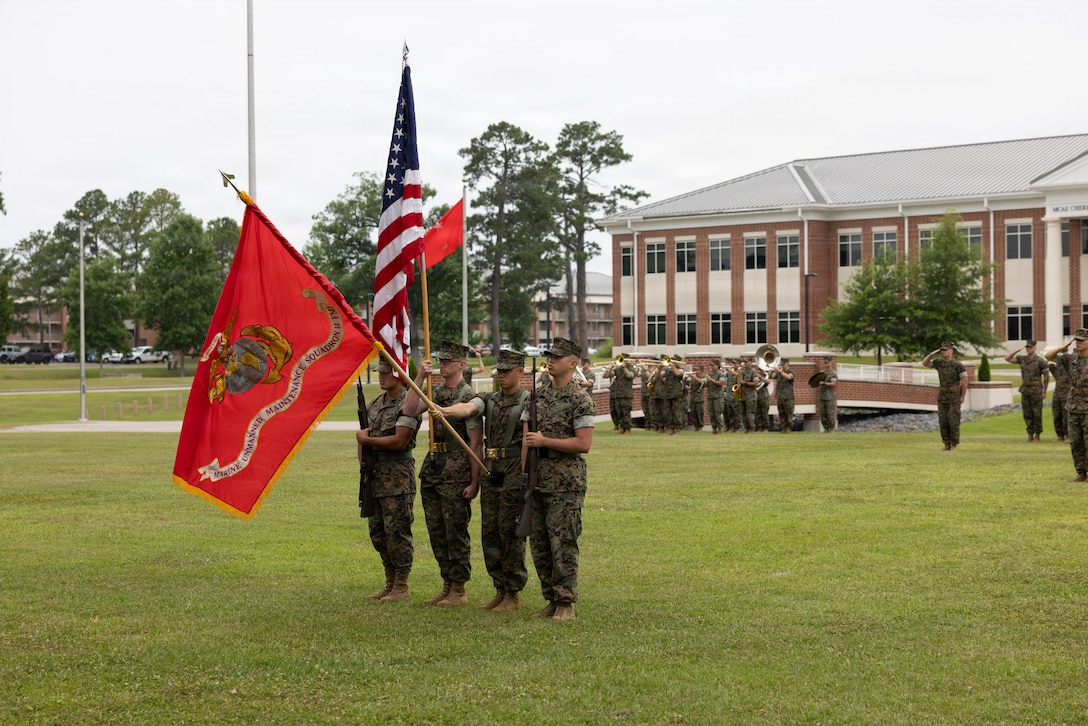 A U.S. Marines Corps color guard with Marine Unmanned Maintenance Squadron (MUMS) 14, Marine Aircraft Group 14, 2nd Marine Aircraft Wing, present the colors during the MUMS-14 activation ceremony at Marine Corps Air Station Cherry Point, North Carolina, June 16, 2026. MUMS-14 serves as the principal provider of organic level maintenance support for the U.S. Marine Corps' Group 5 Unmanned Aerial Systems (UAS) operational and training fleet system of systems. (U.S. Marine Corps photo by Pfc. Keani Guthmueller)