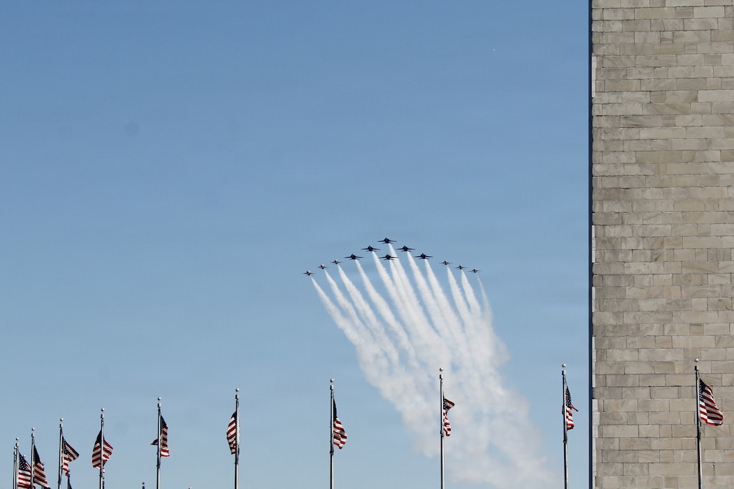 Military aircraft fly over UFC Freedom 250 event.