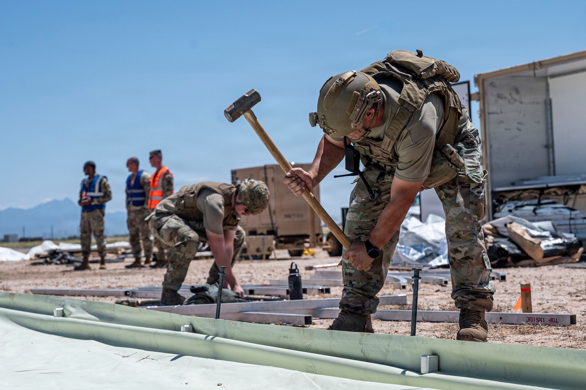 U.S. Airmen establish a tent city during a mock deployment scenario for exercise Mosaic Lightning 26-2 at Davis-Monthan Air Force Base, Arizona, May 10, 2026. Exercises like Mosaic Lightning reinforce the Air Force’s ability to rapidly generate and sustain combat power. (U.S. Air Force photo by Airman 1st Class Samantha Melecio)