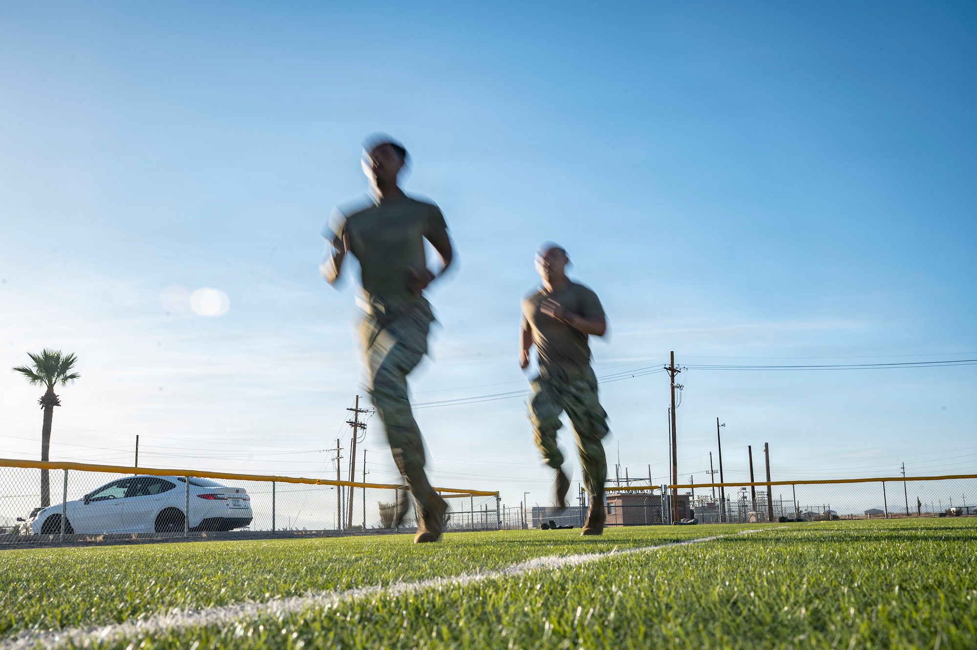 U.S. Air Force 1st Lt. Kevin Liu, financial operations flight commander, and Airman 1st Class Willie Mitchell, financial operations technician assigned to the 355th Comptroller Squadron, run laps at Davis-Monthan Air Force Base, Arizona, May 19, 2026.The Airmen participated in the unit fitness activity to maintain physical readiness and strengthen camaraderie within the squadron. (U.S. Air Force photo by Airman 1st Class Samantha Melecio)