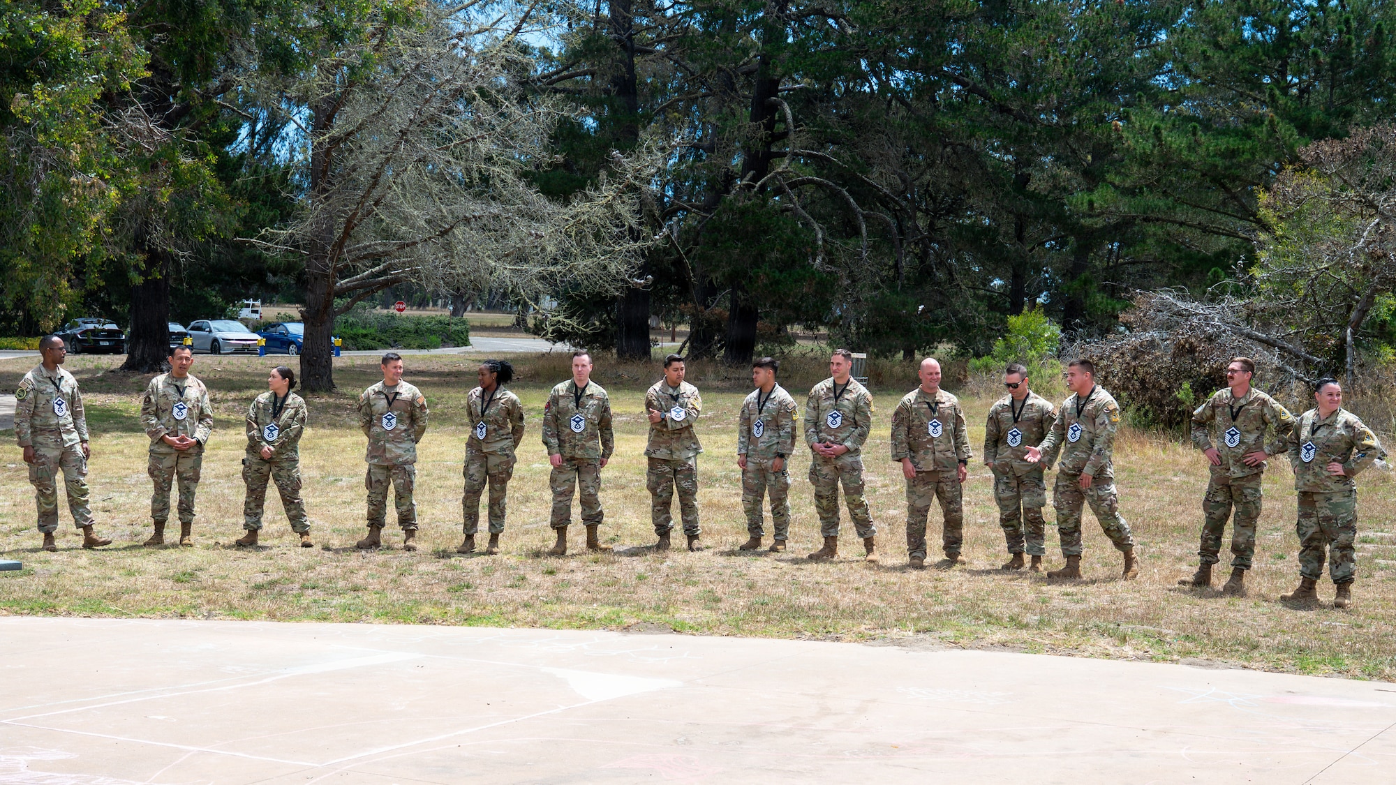 U.S. Air Force Master Sgt. selects stand and wait outside for the initiation of a Master Sgt. release party ceremony