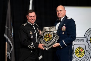 Gen. Chance Saltzman receives a plaque.