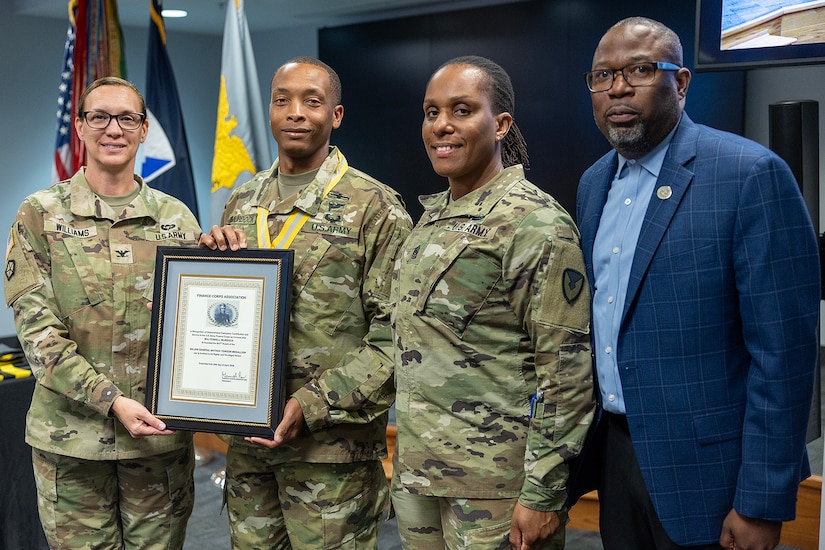Maj. Terrell Murdock, U.S. Army Financial Management Command Army banking officer and executive officer, receives a Maj. Gen. Nathan Towson Regimental Medallion from Col. Michelle M. Williams, USAFMCOM commander, left; Command Sgt. Maj. Joay L. Allen, USAFMCOM senior enlisted advisor, center right; and retired Command Sgt. Maj. Gennaro Penn, Finance Corps Association president at the Maj. Gen. Emmett J. Bean Federal Center in Indianapolis June 15, 2026. The Towson Medallion was established by the U.S. Army Finance Corps Association on May 7, 1993, to recognize exceptional achievement or exemplary service by currently serving U.S. Army finance and comptroller commissioned officers, non-commissioned officers, enlisted Soldiers and civilians demonstrating exceptional leadership and whose accomplishments clearly distinguish them from their peers. (U.S. Army photo by Mark R. W. Orders-Woempner)