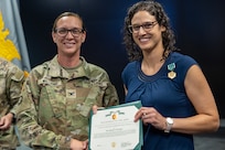 Col. Michelle M. Williams, U.S. Army Financial Management Command commander, presents Karen F. Percinel, USAFMCOM Army Accounting and Audit Operations accountant with a Department of the Army Civilian Service Commendation Medal at the Maj. Gen. Emmett J. Bean Federal Center in Indianapolis June 15, 2026. Percinel was recognized as one of the U.S. Army Materiel Command top employees of the quarter for the Fiscal Year 2026 second quarter. (U.S. Army photo by Mark R. W. Orders-Woempner)