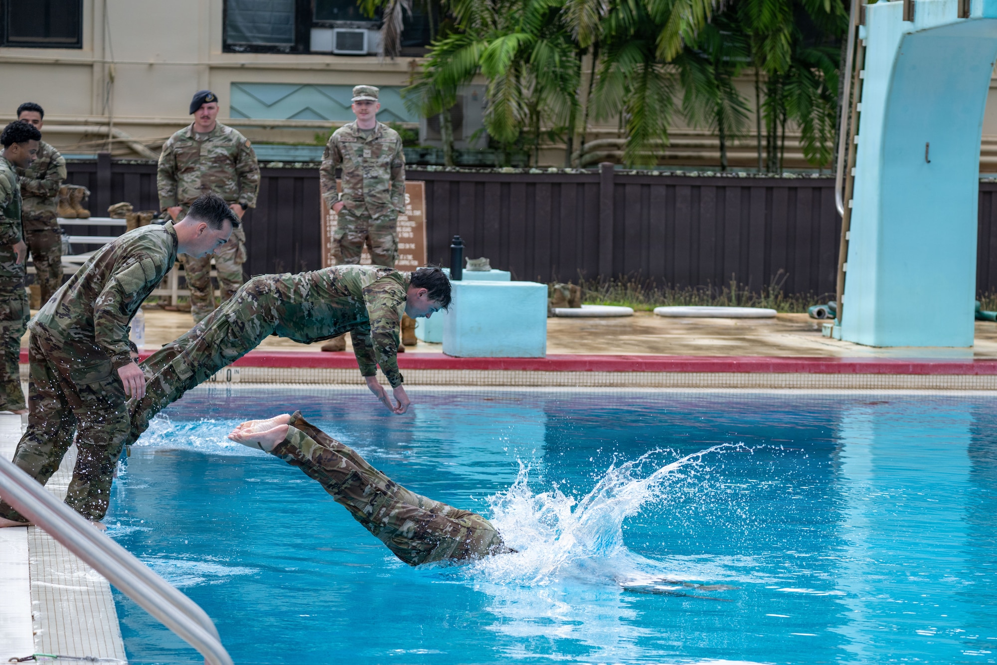 U.S. Air Force Airmen dive into a pool during water survival training during Vanguard Expeditionary Training 02-26.