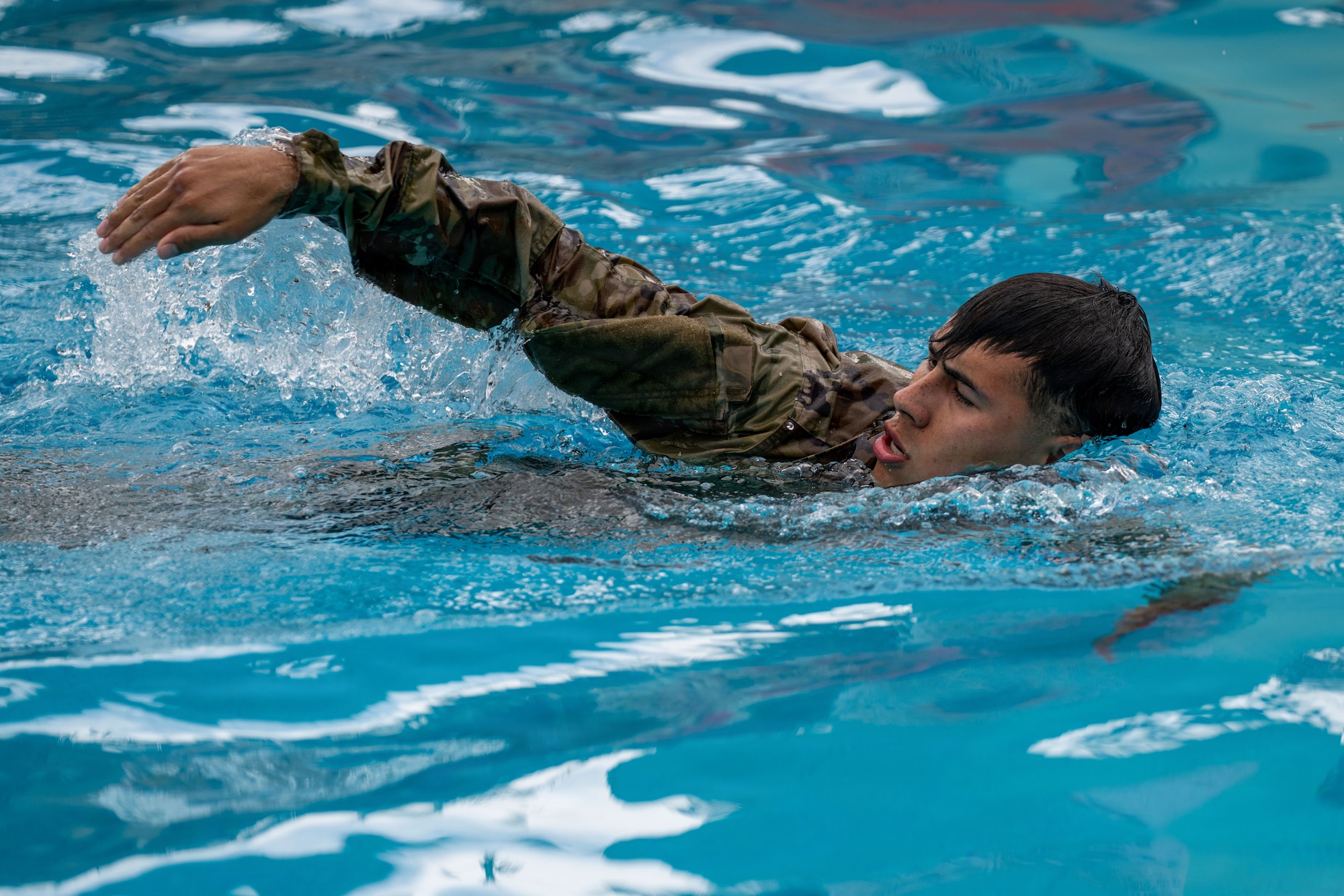 A U.S. Air Force Airman swims in a pool for water survival training during Vanguard Expeditionary Training 02-26.