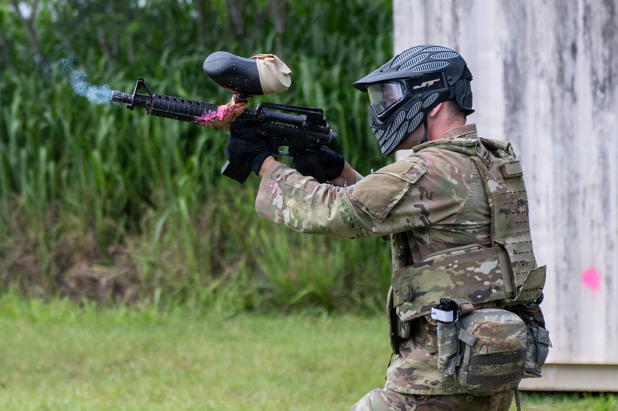 A U.S. Air Force Airman shoots a paintball gun during a combat lifesaver course for Vanguard Expeditionary Training 02-26.