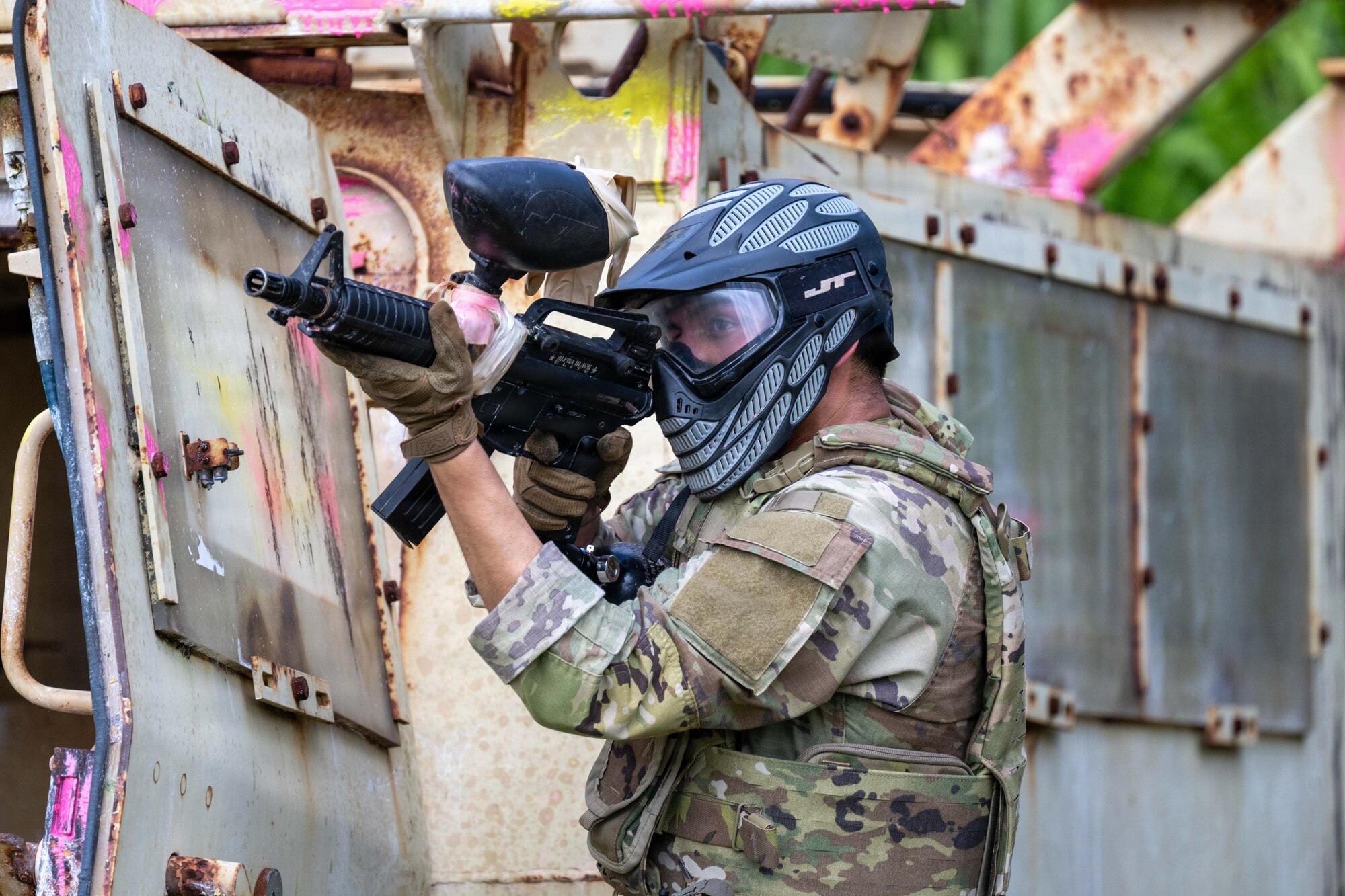 A U.S. Air Force Airman shoots a paintball gun during a combat lifesaver course for Vanguard Expeditionary Training 02-26.