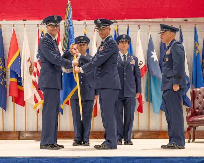 Col. Chris Keithley, 96th Test Wing commander, takes the 96th TW guidon from Maj. Gen. Scott Cain, Air Force Test Center commander, June 16, 2026 at the 96th TW change of command ceremony at the McKinley Climatic Lab.