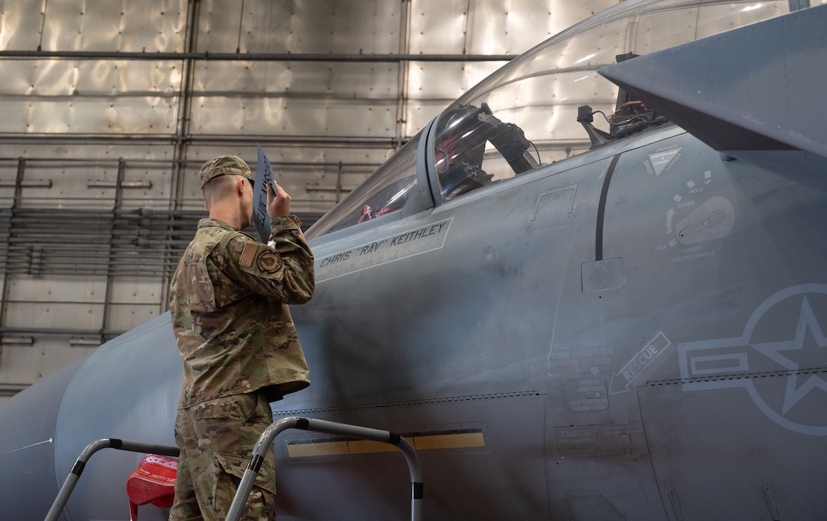 Staff Sgt. Nicholas Kunets, 96th Aircraft Maintenance Squadron Red Aircraft Maintenance Unit, reveals Col. Chris Keithley’s, the new 96th Test Wing commander, name on an F-15 EX Super Eagle during the 96th TW’s change of command ceremony June 16, 2026 at the McKinley Climatic Lab.