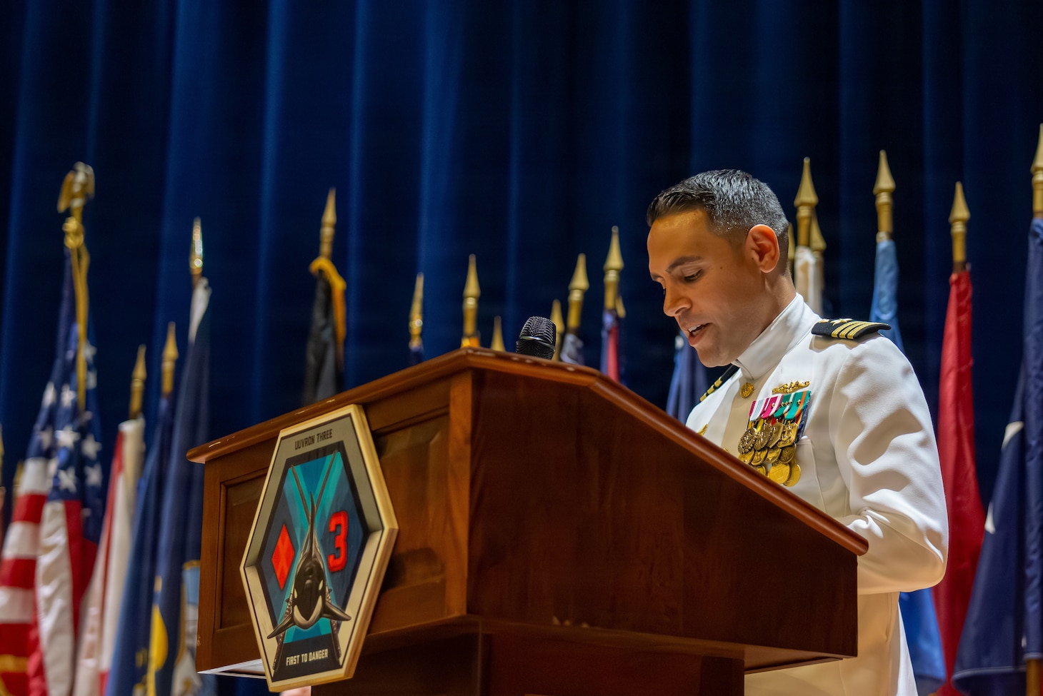 Naval Base Ventura County, Calif. (May 21, 2026) Cmdr. Andrew Lichtenstein, outgoing commanding officer of Unmanned Undersea Vehicle Squadron (UUVRON) 3, delivers remarks during the UUVRON 3 change of command ceremony at Needham Theater at Naval Base Port Hueneme, May 21, 2026. UUVRON 3’s mission is to tactically operate and maintain XLUUVs fleetwide. (U.S. Navy photo by Logistics Specialist 1st Class Paul Villalobos)