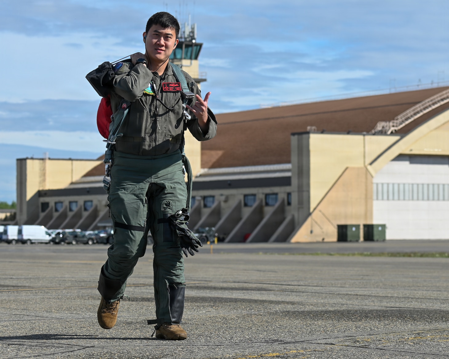 Republic of Singapore Air Force Maj. Music Leong, a F-16 Fighting Falcon pilot assigned to the 425th Fighter Squadron from Luke Air Force Base, Ariz., gives a unit’s heritage hand sign on the flight line during RED FLAG-Alaska 26-2 at Eielson Air Force Base, Alaska, June 1, 2026. The sign represents unit heritage and pride before a sortie. The 425th FS is composed of U.S. Air Force and RSAF personnel and provides long-term F-16 training for RSAF pilots and maintenance crews. (U.S. Air Force photo by Tech. Sgt. Kentavist P. Brackin)