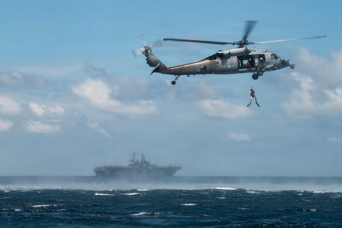 A U.S. Navy Sailor assigned to Helicopter Sea Combat Squadron (HSC) 21 conducts search and rescue qualifications alongside Wasp-class amphibious assault ship USS Boxer (LHD 4), June 12, 2026.