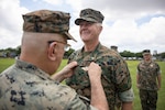 U.S. Navy Rear Adm. Anthony Lacourse, reserve medical officer, Marine Forces Reserve, pins Fleet Marine Force insignia on Lt. Cmdr. David Westenberg, a dentist, 4th Dental Battalion, during a Fleet Marine Force (FMF) pinning ceremony at Marine Force Support Facility New Orleans, June 11, 2026. The FMF Warfare Insignia is earned by Sailors assigned to FMF units and signifies that a Sailor has achieved a required level of excellence and proficiency with an enhanced comprehension of Marine Corps warfighting, mission effectiveness, and command survivability. (U.S. Marine Corps photo by Staff Sgt. Scott Jenkins)