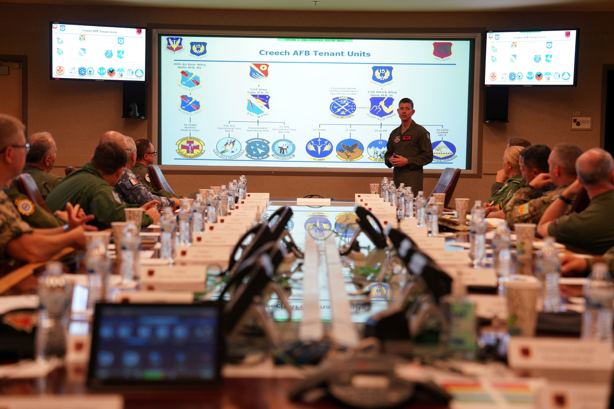 Members of the International Air and Space Attachés attend a Mission Brief during an orientation tour at Creech Air Force Base, Nevada, June 12, 2026. The International Air and Space Attachés visited the installation to gain a deeper understanding of Air Force capabilities and operational readiness (U.S. Air Force photo by Airman Vinh Phan)