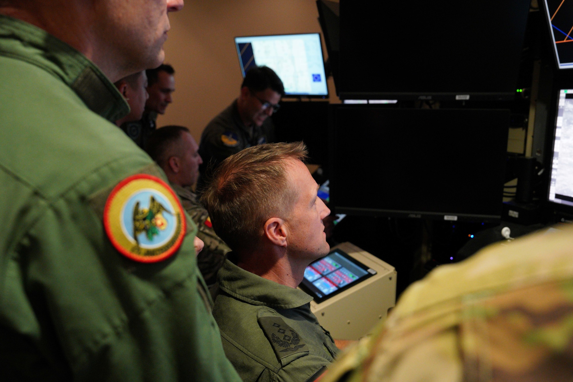 Members of the International Air and Space Attachés interact with MQ-9 simulators during an orientation tour at Creech Air Force Base, Nevada, June 12, 2026. The MQ-9 simulators were created to allow RPA pilots to apply knowledge from the classroom to actual scenarios. (U.S. Air Force photo by Airman Vinh Phan)