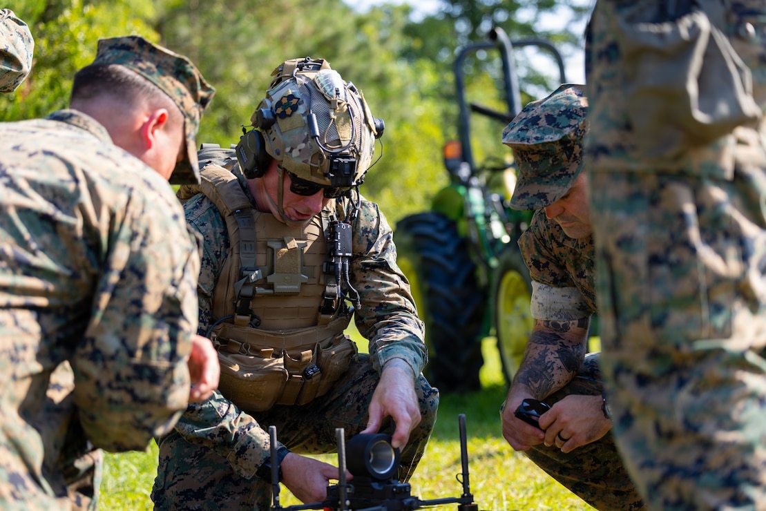 U.S. Marine Corps Sgt. Dakota Meyer, center, a student with Small Unmanned Aircraft Systems School, Advanced Infantry Training Battalion, School of Infantry – East, prepares a Neros Archer first-person view drone during the Attack Drone Operator course capstone event on Marine Corps Base Camp Lejeune, North Carolina