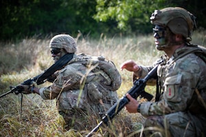 U.S. Army Soldiers Spc. Renato Medina and Staff Sgt. Cody Merrifield, infantrymen with 1st Infantry Division, III Armored Corps, react to contact during the medical trauma evacuation lane at the IIIAC Best Squad Competition on June 3, 2026 at Fort Hood, Texas. The Army Best Squad Competition brings together top-performing Soldiers to compete in a series of demanding events designed to assess tactical competence, leadership, fitness, and squad cohesion. (U.S. Army photo by Sgt. 1st Class Thomas Calvert)