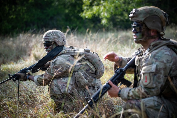U.S. Army Soldiers Spc. Renato Medina and Staff Sgt. Cody Merrifield, infantrymen with 1st Infantry Division, III Armored Corps, react to contact during the medical trauma evacuation lane at the IIIAC Best Squad Competition on June 3, 2026 at Fort Hood, Texas. The Army Best Squad Competition brings together top-performing Soldiers to compete in a series of demanding events designed to assess tactical competence, leadership, fitness, and squad cohesion. (U.S. Army photo by Sgt. 1st Class Thomas Calvert)