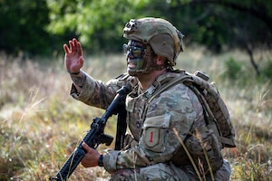 U.S. Army Staff Sgt. Cody Merrifield, an infantryman with 1st Infantry Division, III Armored Corps, signals his squad during the medical trauma evacuation lane at the IIIAC Best Squad Competition on June 3, 2026 at Fort Hood, Texas. The Army Best Squad Competition brings together top-performing Soldiers to compete in a series of demanding events designed to assess tactical competence, leadership, fitness, and squad cohesion. (U.S. Army photo by Sgt. 1st Class Thomas Calvert)