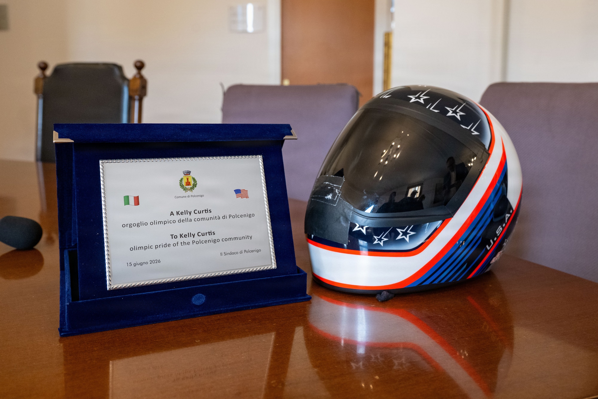A helmet and plaque sit next to each other on a table