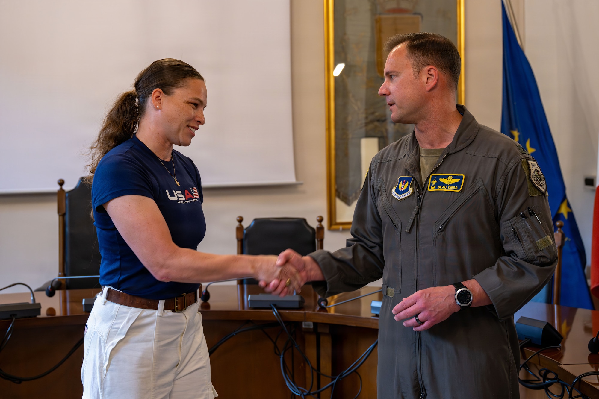A man and woman shake hands