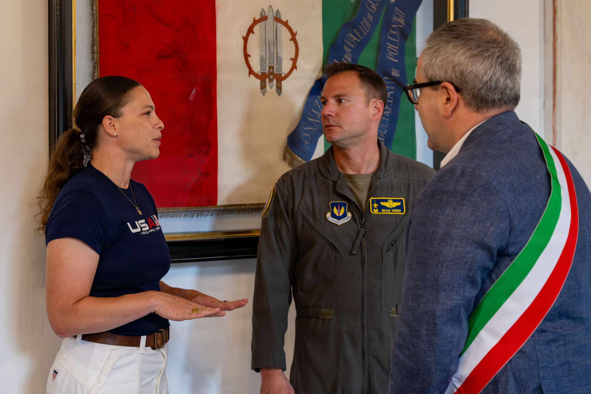 A woman talks to two men