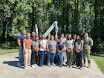 FREDERICK, Md. (June 16, 2026) Kimberly Bishop-Lilly (first row, third from left) poses for a photo with members of Naval Medical Research Command’s (NMRC) Genomics & Bioinformatics Department. Bishop-Lilly was selected as a recipient of the Assistant Secretary of the Navy (Research, Development and Acquisition) 2026 Dr. Delores M. Etter Top Scientists and Engineers of the Year Award in the Individual Scientist category. NMRC, headquarters of Navy Medicine Research & Development, is engaged in a broad spectrum of activity from basic science in the laboratory to field studies in austere and remote areas of the world to investigations in operational environments. In support of Navy, Marine Corps and joint U.S. warfighter health, readiness and lethality, researchers study infectious diseases, biological warfare detection and defense, combat casualty care, environmental health concerns, aerospace and undersea medicine, operational mission support and epidemiology. Navy Medicine’s 44,000+ talented and ready forces optimize health readiness, deliver quality healthcare and provide global expeditionary medical support to warfighters. (U.S. Navy photo by Deirdre Coffey/released)