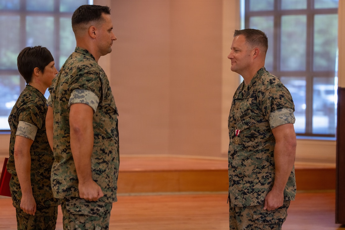 U.S. Marine Corps Sgt. Maj. Casey S. Chandler, outgoing senior enlisted leader for 2nd Network Battalion, Marine Corps Cyberspace Operations Group, holds the sword of office during a relief and appointment ceremony at Marine Corps Base Camp Lejeune, North Carolina, June 2, 2026. 2nd Network Bn held the ceremony to mark the transition of its senior enlisted leadership, signifying the transfer of all responsibilities and authorities between the outgoing and incoming sergeants major.  (U.S. Marine Corps Photo by Cpl. Jessica J. Mazzamuto)