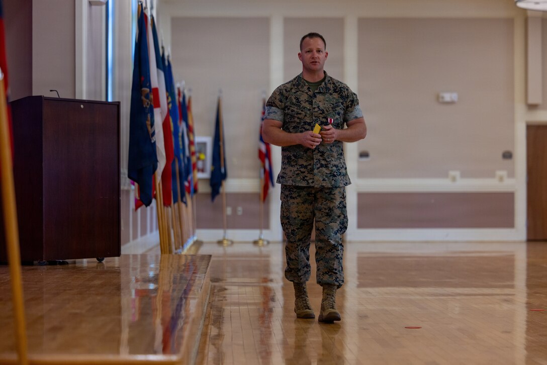 U.S. Marine Corps Sgt. Maj. Casey S. Chandler, outgoing senior enlisted leader for 2nd Network Battalion, Marine Corps Cyberspace Operations Group, holds the sword of office during a relief and appointment ceremony at Marine Corps Base Camp Lejeune, North Carolina, June 2, 2026. 2nd Network Bn held the ceremony to mark the transition of its senior enlisted leadership, signifying the transfer of all responsibilities and authorities between the outgoing and incoming sergeants major.  (U.S. Marine Corps Photo by Cpl. Jessica J. Mazzamuto)