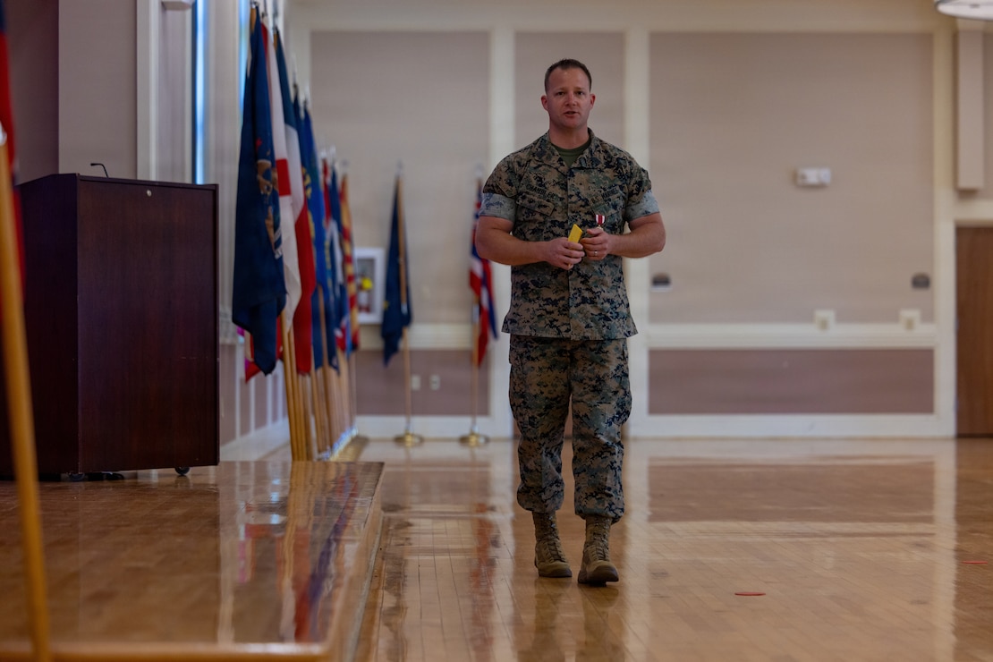 U.S. Marine Corps Sgt. Maj. Casey S. Chandler, outgoing senior enlisted leader for 2nd Network Battalion, Marine Corps Cyberspace Operations Group, holds the sword of office during a relief and appointment ceremony at Marine Corps Base Camp Lejeune, North Carolina, June 2, 2026. 2nd Network Bn held the ceremony to mark the transition of its senior enlisted leadership, signifying the transfer of all responsibilities and authorities between the outgoing and incoming sergeants major.  (U.S. Marine Corps Photo by Cpl. Jessica J. Mazzamuto)
