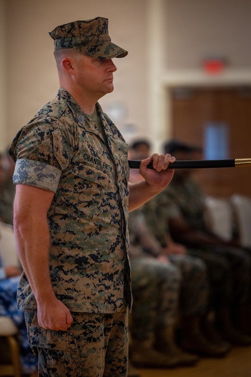 U.S. Marine Corps Sgt. Maj. Casey S. Chandler, outgoing senior enlisted leader for 2nd Network Battalion, Marine Corps Cyberspace Operations Group, holds the sword of office during a relief and appointment ceremony at Marine Corps Base Camp Lejeune, North Carolina, June 2, 2026. 2nd Network Bn held the ceremony to mark the transition of its senior enlisted leadership, signifying the transfer of all responsibilities and authorities between the outgoing and incoming sergeants major.  (U.S. Marine Corps Photo by Cpl. Jessica J. Mazzamuto)