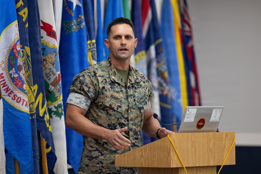 Retired U.S. Marine Corps Lt. Col. Karl W. Schlegel, center, the first commanding officer of 2nd Network Battalion, Marine Corps Cyberspace Operations Group, hands a slice of cake to Sgt. Mera N. Creamer, admin clerk, 2nd Network Battalion, MCCOG, during 2nd Network Bn’s 5th birthday ceremony at Marine Corps Base Camp Lejeune, North Carolina, June 3, 2026. 2nd Network Bn was activated on June 3, 2021, to ensure the operation of a resilient network that enables mission execution in the face of persistent cyber threats. (U.S. Marine Corps photo by Lance Cpl. Alyssa J. DeCrane)