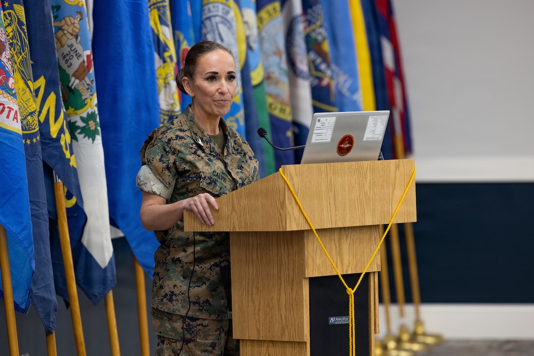 Retired U.S. Marine Corps Lt. Col. Karl W. Schlegel, center, the first commanding officer of 2nd Network Battalion, Marine Corps Cyberspace Operations Group, hands a slice of cake to Sgt. Mera N. Creamer, admin clerk, 2nd Network Battalion, MCCOG, during 2nd Network Bn’s 5th birthday ceremony at Marine Corps Base Camp Lejeune, North Carolina, June 3, 2026. 2nd Network Bn was activated on June 3, 2021, to ensure the operation of a resilient network that enables mission execution in the face of persistent cyber threats. (U.S. Marine Corps photo by Lance Cpl. Alyssa J. DeCrane)