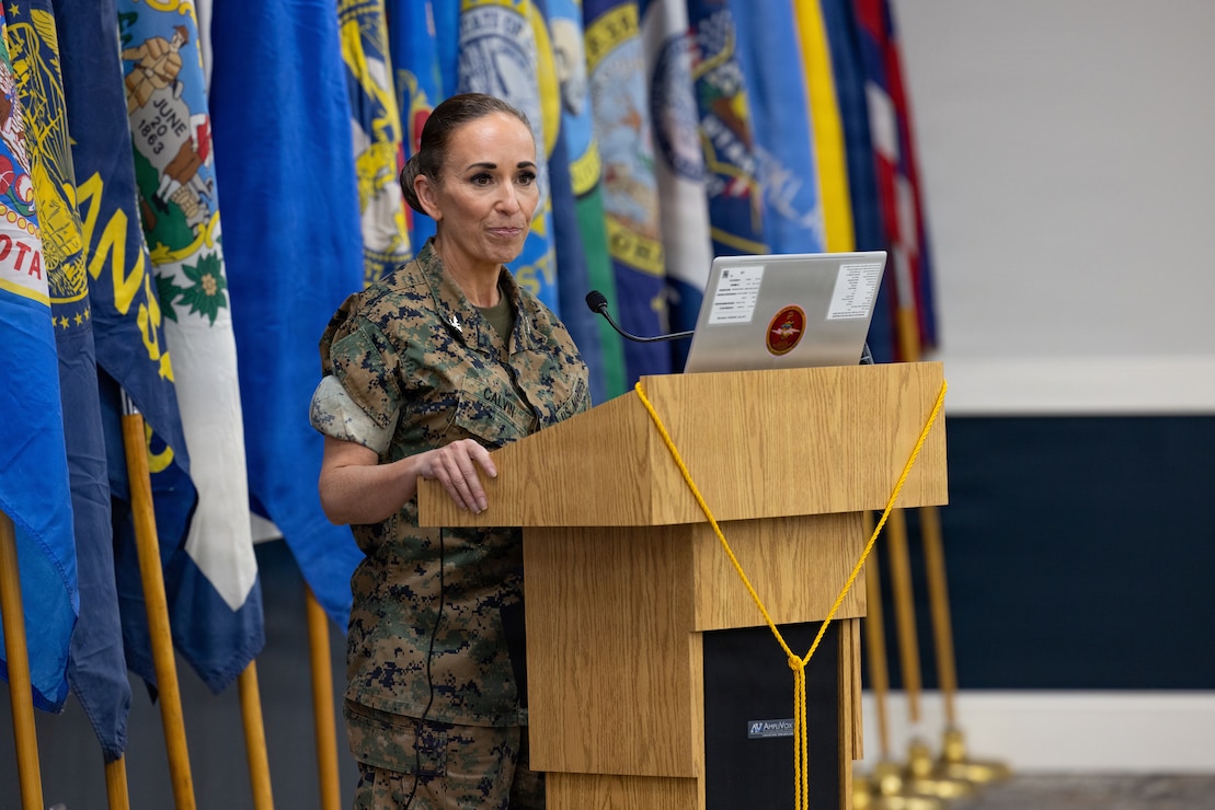 Retired U.S. Marine Corps Lt. Col. Karl W. Schlegel, center, the first commanding officer of 2nd Network Battalion, Marine Corps Cyberspace Operations Group, hands a slice of cake to Sgt. Mera N. Creamer, admin clerk, 2nd Network Battalion, MCCOG, during 2nd Network Bn’s 5th birthday ceremony at Marine Corps Base Camp Lejeune, North Carolina, June 3, 2026. 2nd Network Bn was activated on June 3, 2021, to ensure the operation of a resilient network that enables mission execution in the face of persistent cyber threats. (U.S. Marine Corps photo by Lance Cpl. Alyssa J. DeCrane)