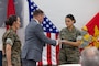 Retired U.S. Marine Corps Lt. Col. Karl W. Schlegel, center, the first commanding officer of 2nd Network Battalion, Marine Corps Cyberspace Operations Group, hands a slice of cake to Sgt. Mera N. Creamer, admin clerk, 2nd Network Battalion, MCCOG, during 2nd Network Bn’s 5th birthday ceremony at Marine Corps Base Camp Lejeune, North Carolina, June 3, 2026. 2nd Network Bn was activated on June 3, 2021, to ensure the operation of a resilient network that enables mission execution in the face of persistent cyber threats. (U.S. Marine Corps photo by Lance Cpl. Alyssa J. DeCrane)