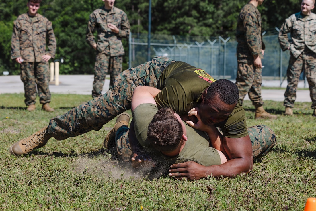 U.S. Marine Corps Gunnery Sgt. Bassey Ekon, right, staff noncommissioned officer in charge, 2nd Network Battalion, Marine Corps Cyberspace Operations Group, Marine Corps Forces Cyberspace Command, grapples during 2nd Network Battalion’s 5th birthday celebration at Marine Corps Base Camp Lejeune, North Carolina, June 4, 2026. 2nd Network Battalion was activated on June 3, 2021, to ensure the operation of a resilient network that enables mission execution in the face of persistent cyber threats. (U.S. Marine Corps photo by Cpl Daniela Chicas Torres)